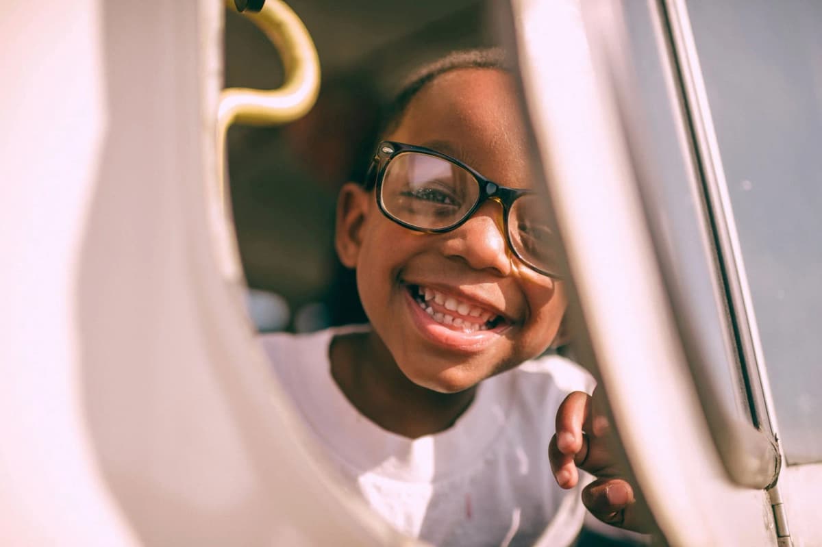 A smiling child wearing glasses
