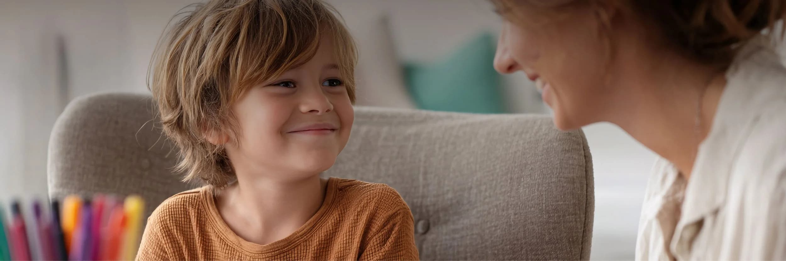 A child smiling with their speech pathologist